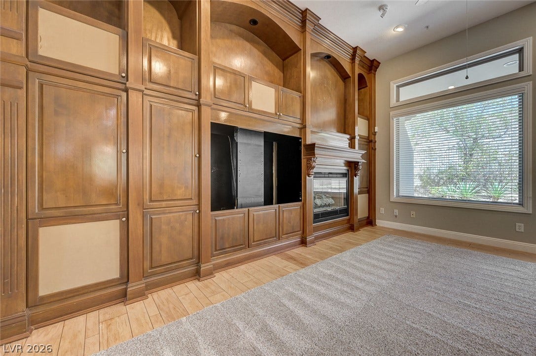 8 Starbrook Drive, Henderson, NV 89052 Rich wood built-ins and a fireplace elevate this comfortable living space.