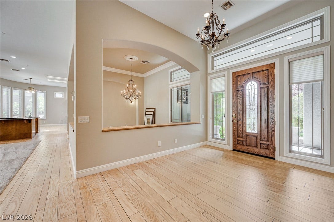 8 Starbrook Drive, Henderson, NV 89052 An inviting entrance foyer welcomes guests with rich hardwood flooring and a handsome wood door.