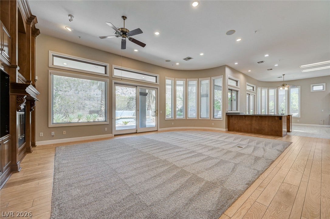 8 Starbrook Drive, Henderson, NV 89052 Gleaming hardwood floors and a wall of windows define this spacious, light-filled interior.