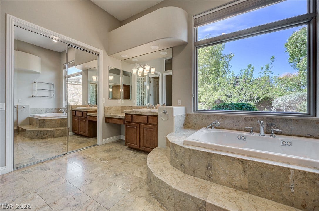 8 Starbrook Drive, Henderson, NV 89052 Natural light streams through a large window overlooking the deep soaking tub and tile floors.