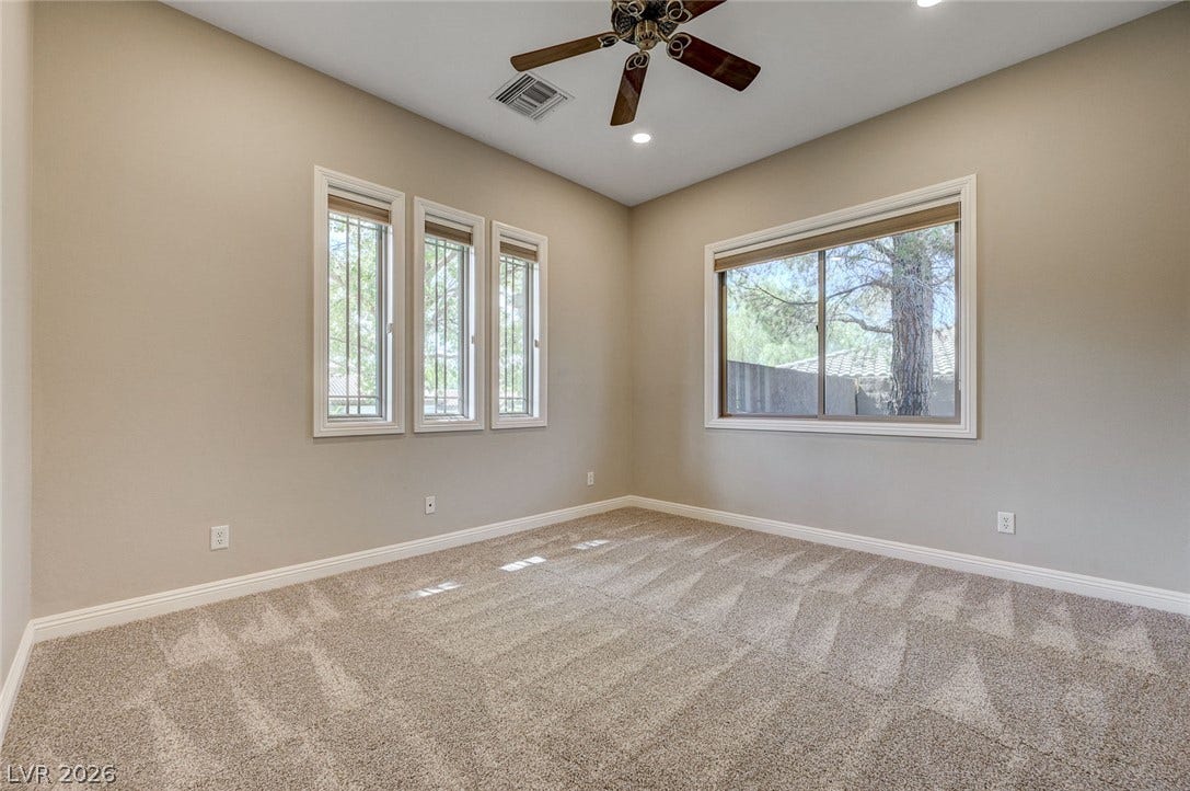 8 Starbrook Drive, Henderson, NV 89052 Plentiful natural light streams through multiple windows across plush carpeted flooring.