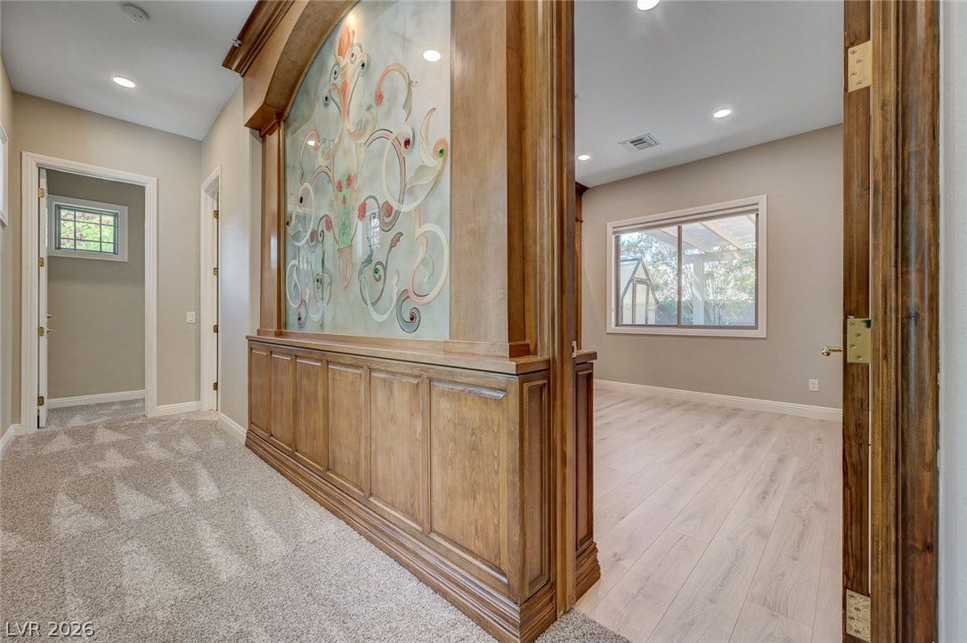8 Starbrook Drive, Henderson, NV 89052 Fine woodwork and an artistic glass divider line the hallway leading to flexible living spaces.