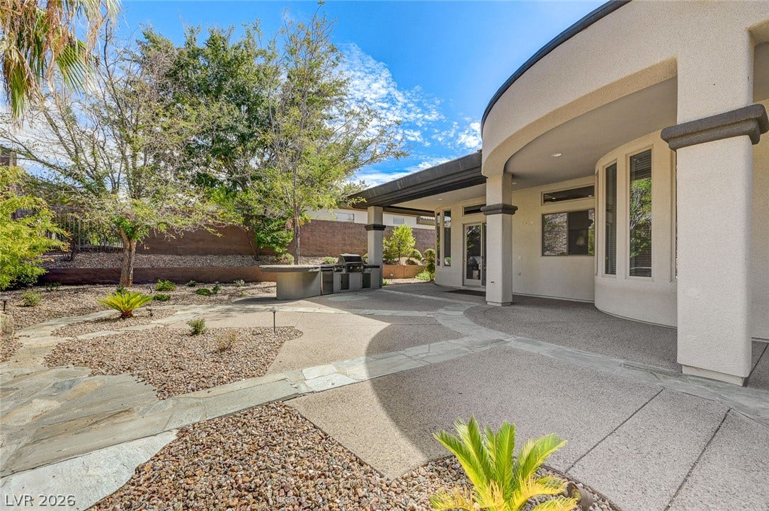 8 Starbrook Drive, Henderson, NV 89052 An expansive covered patio overlooks the low-maintenance desert landscaping and built-in barbecue station.