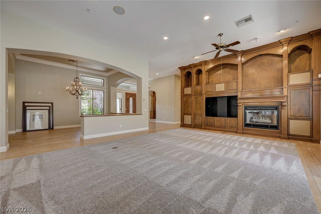 8 Starbrook Drive, Henderson, NV 89052 Fine woodwork and an arched entryway define this grand living space with built-ins.