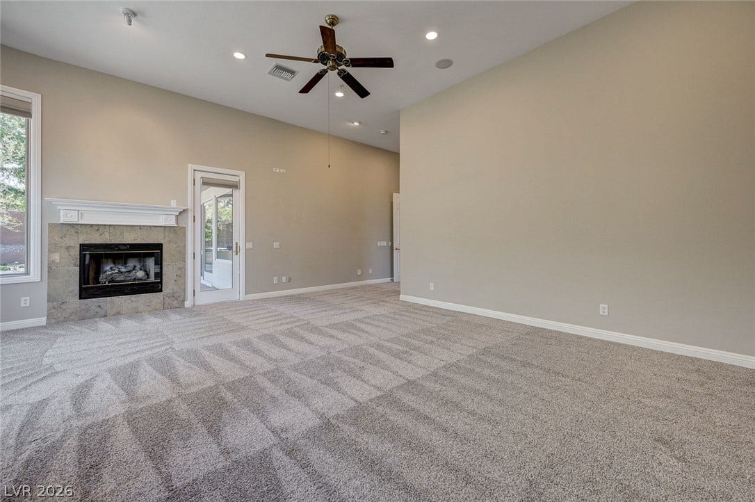 8 Starbrook Drive, Henderson, NV 89052 Plush carpeting anchors this spacious room centered around a classic fireplace and high ceilings.