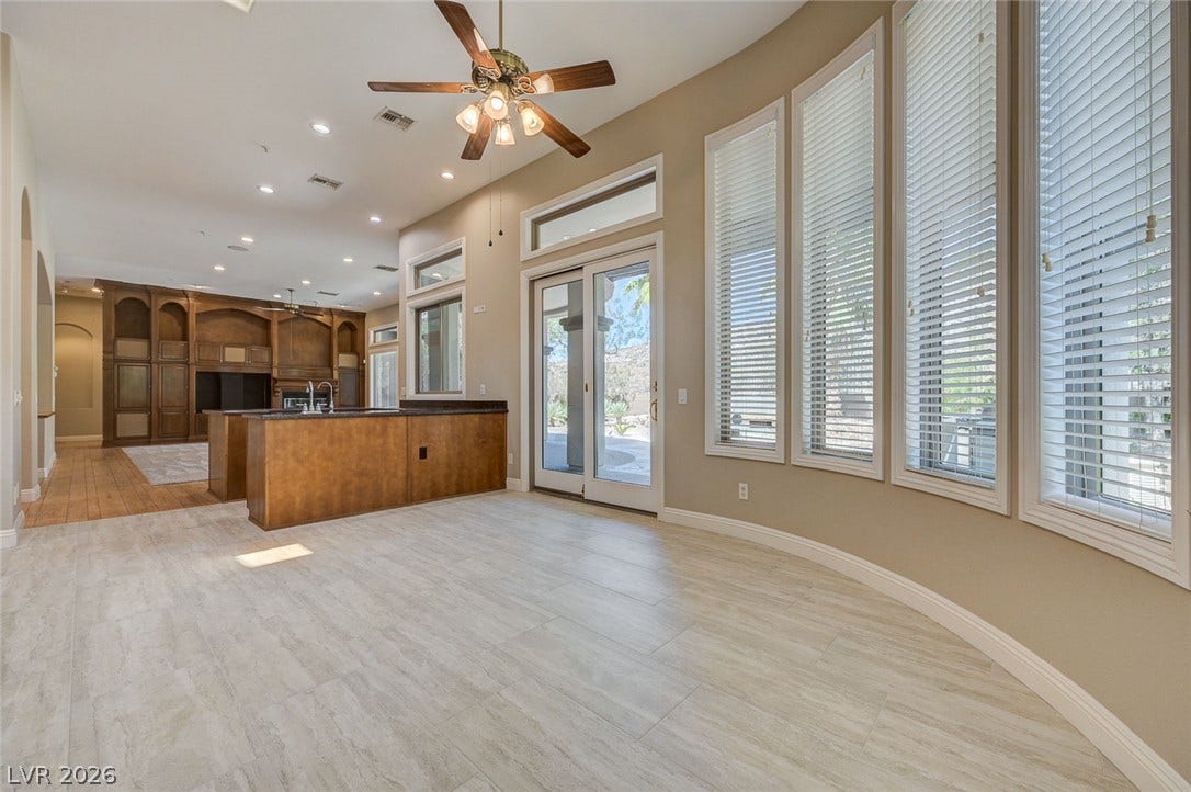 8 Starbrook Drive, Henderson, NV 89052 Light-filled dining area features curved walls, extensive windows, and durable tile flooring.