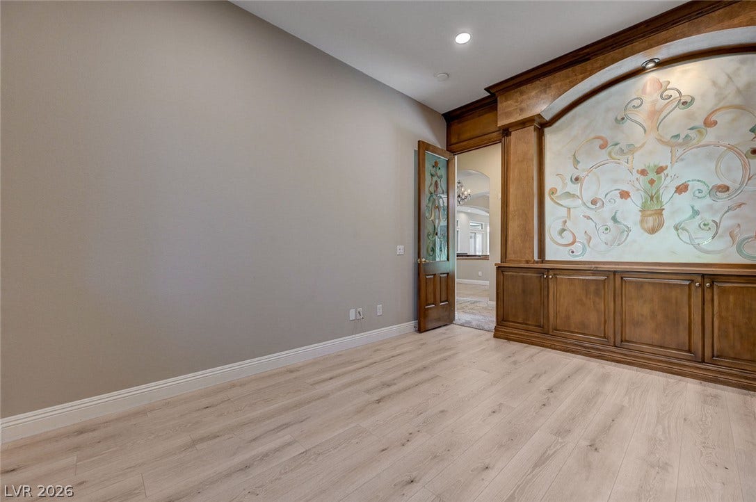 8 Starbrook Drive, Henderson, NV 89052 Rich wood built-ins and custom glass doors elevate this versatile interior space.