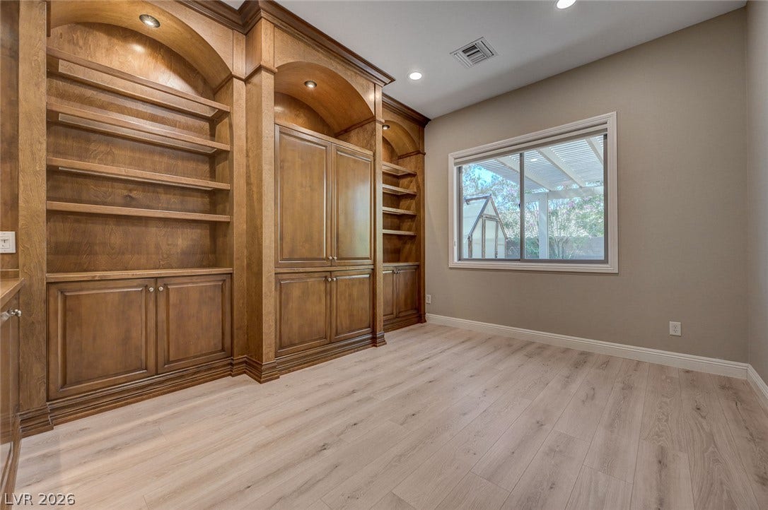 8 Starbrook Drive, Henderson, NV 89052 Rich wood built-ins and smooth laminate flooring create a refined, functional workspace.