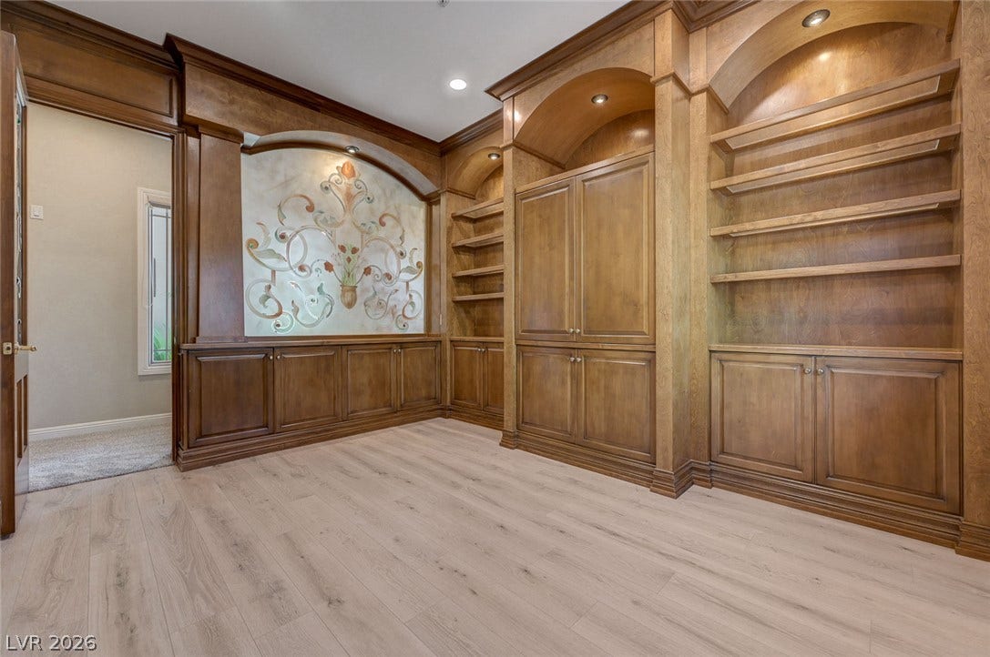 8 Starbrook Drive, Henderson, NV 89052 Rich wood built-ins and custom cabinetry elevate this versatile home workspace.