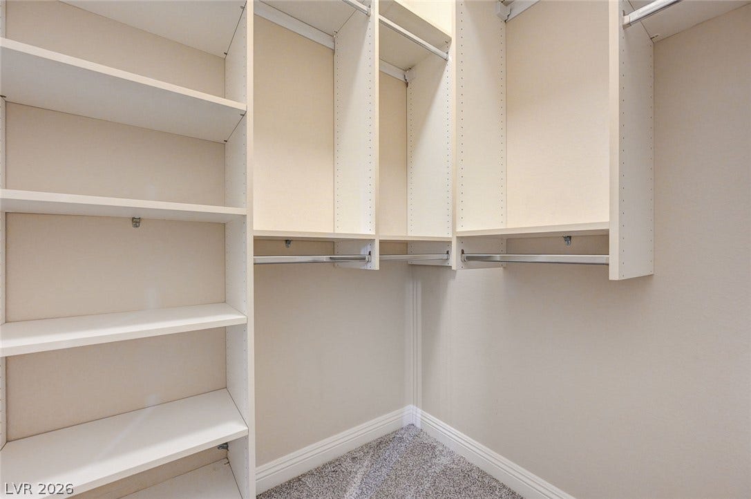 8 Starbrook Drive, Henderson, NV 89052 Custom built-in shelving and hanging rods maximize storage space within this walk-in closet.