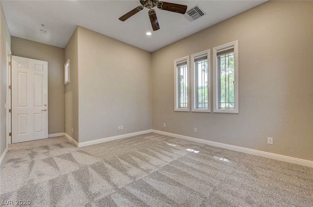 8 Starbrook Drive, Henderson, NV 89052 Plush carpeting anchors this versatile room under high ceilings and recessed lighting.