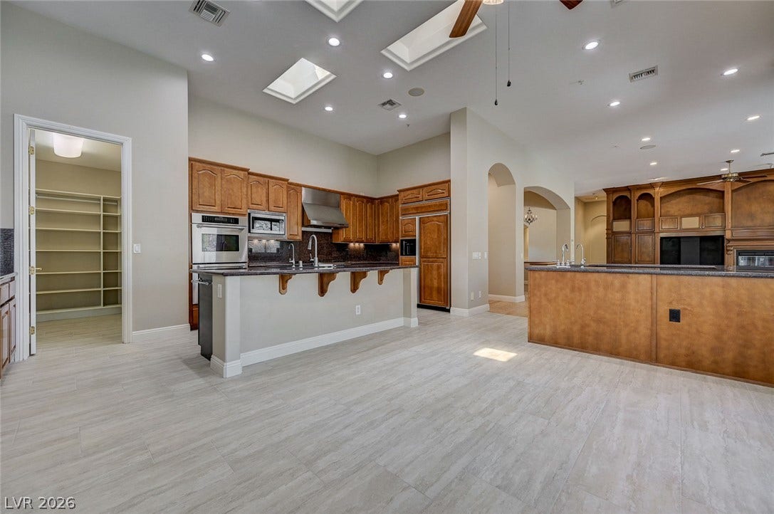 8 Starbrook Drive, Henderson, NV 89052 Natural light pours through skylights over this expansive kitchen featuring dual islands and custom cabinetry.