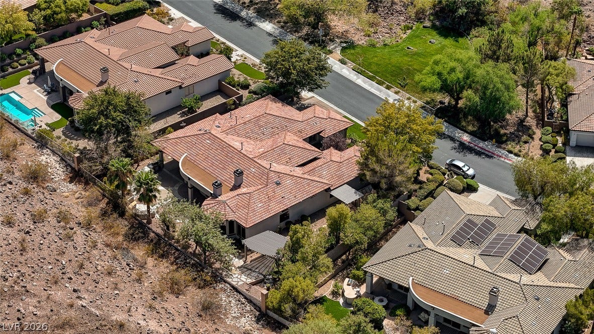 8 Starbrook Drive, Henderson, NV 89052 An aerial perspective showcases Spanish tile roofing nestled within desert landscaping.