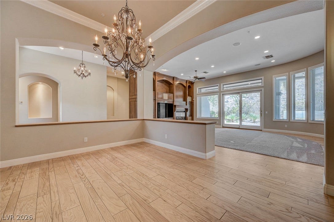 8 Starbrook Drive, Henderson, NV 89052 Polished wood floors and detailed crown molding elevate this open dining and living space.