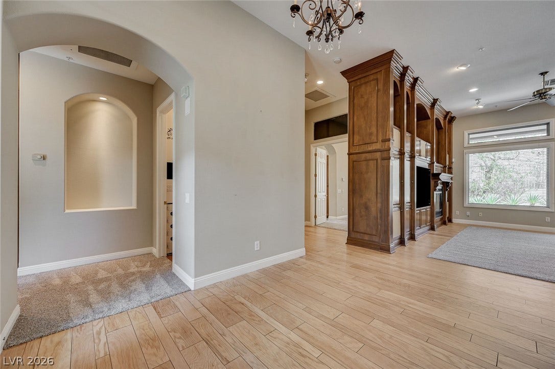 8 Starbrook Drive, Henderson, NV 89052 Gleaming hardwood floors and a striking wood built-in unit anchor this open layout.