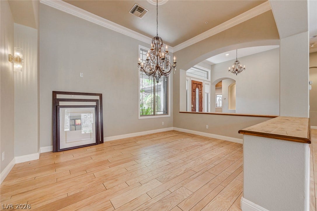 8 Starbrook Drive, Henderson, NV 89052 Gleaming hardwood floors and a classic chandelier define this open formal dining space.