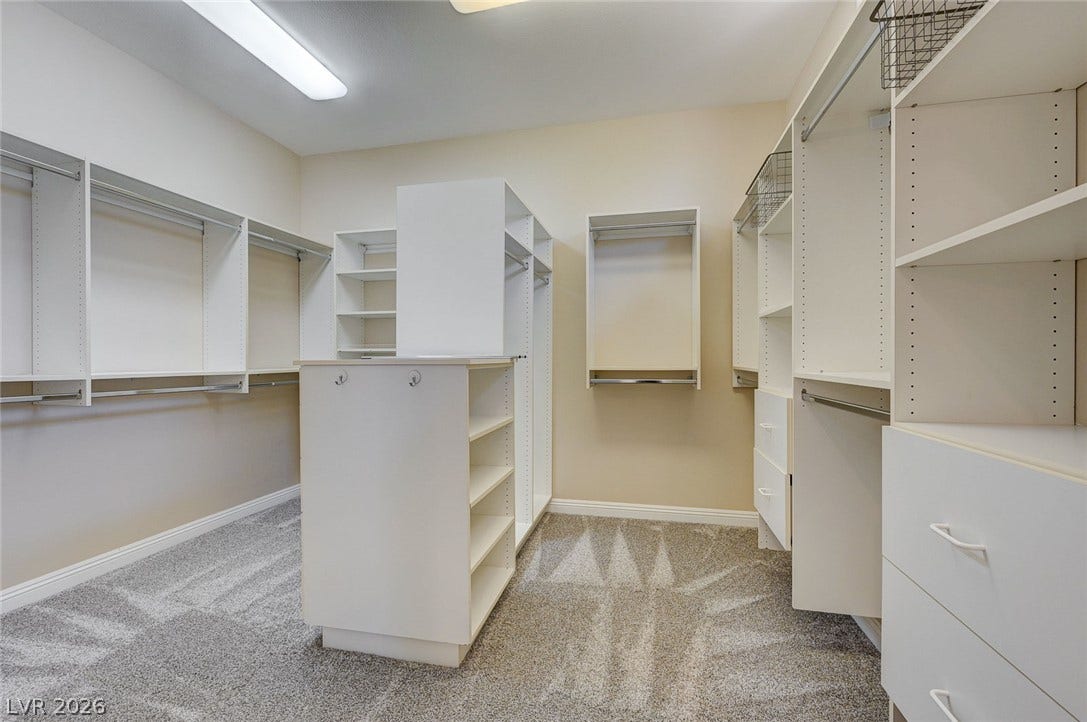 8 Starbrook Drive, Henderson, NV 89052 A spacious walk-in closet boasts extensive custom built-in shelving and soft carpeting.