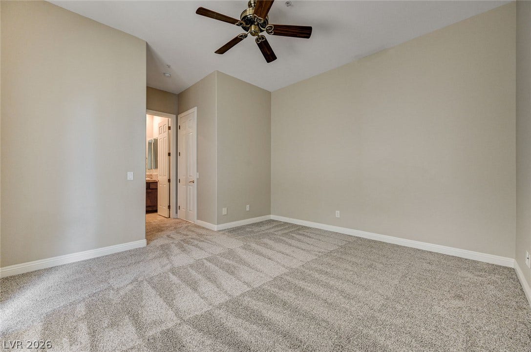 8 Starbrook Drive, Henderson, NV 89052 Plush carpeting and neutral walls define this comfortable bedroom space.