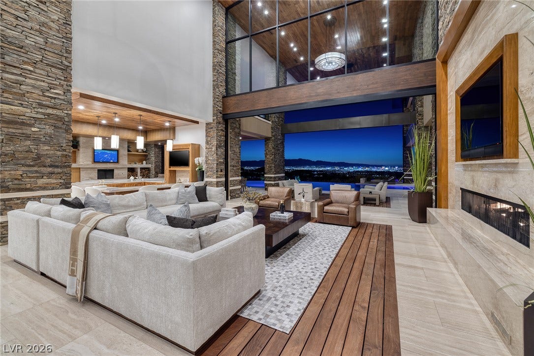 761 Dragon Ridge Drive, Henderson, NV 89012 Towering ceilings and stone-clad walls frame a dramatic indoor-outdoor living space with city views.