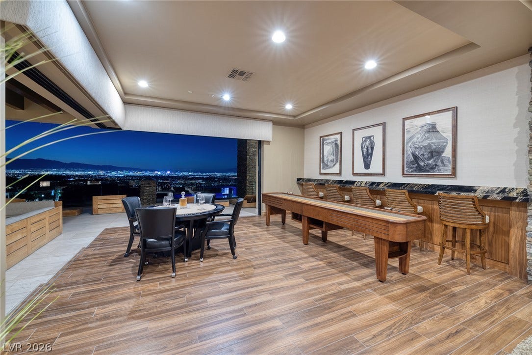 761 Dragon Ridge Drive, Henderson, NV 89012 Gleaming wood-look tile floors and recessed lighting enhance this entertainment room opening to city views.