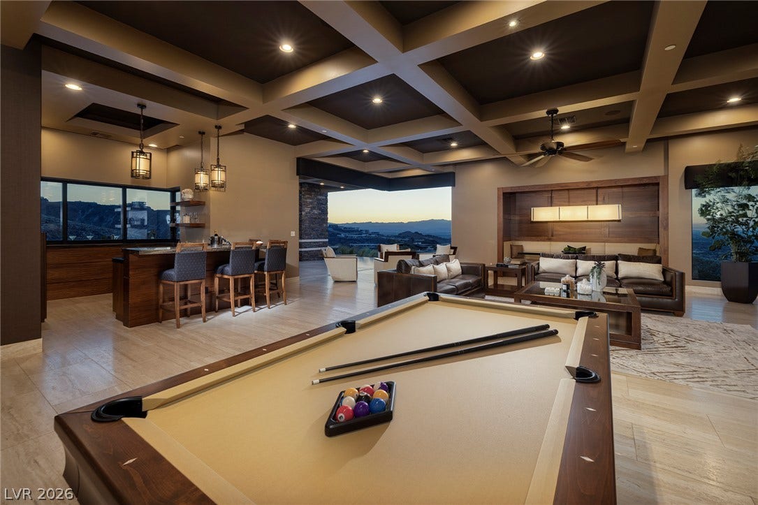 761 Dragon Ridge Drive, Henderson, NV 89012 Exquisite coffered ceilings crown this spacious game room flowing out to scenic mountain views.