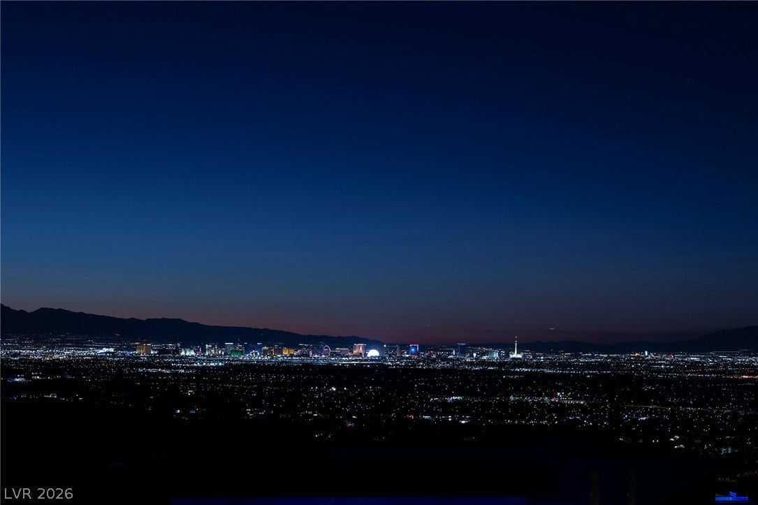 761 Dragon Ridge Drive, Henderson, NV 89012 Sparkling city lights stretch across the valley floor under a deep twilight sky.
