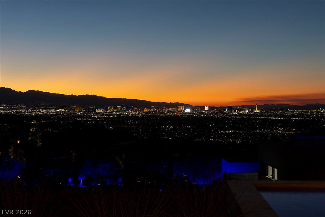 761 Dragon Ridge Drive, Henderson, NV 89012 Gaze across the sparkling valley to a distant skyline framed by mountain ridges at dusk.