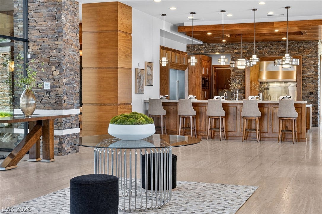 761 Dragon Ridge Drive, Henderson, NV 89012 Stone pillars and rich woodwork define this seamlessly integrated, open concept space.
