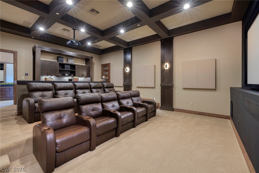 761 Dragon Ridge Drive, Henderson, NV 89012 A magnificent coffered ceiling and built-in wet bar highlight this dedicated home theater room.