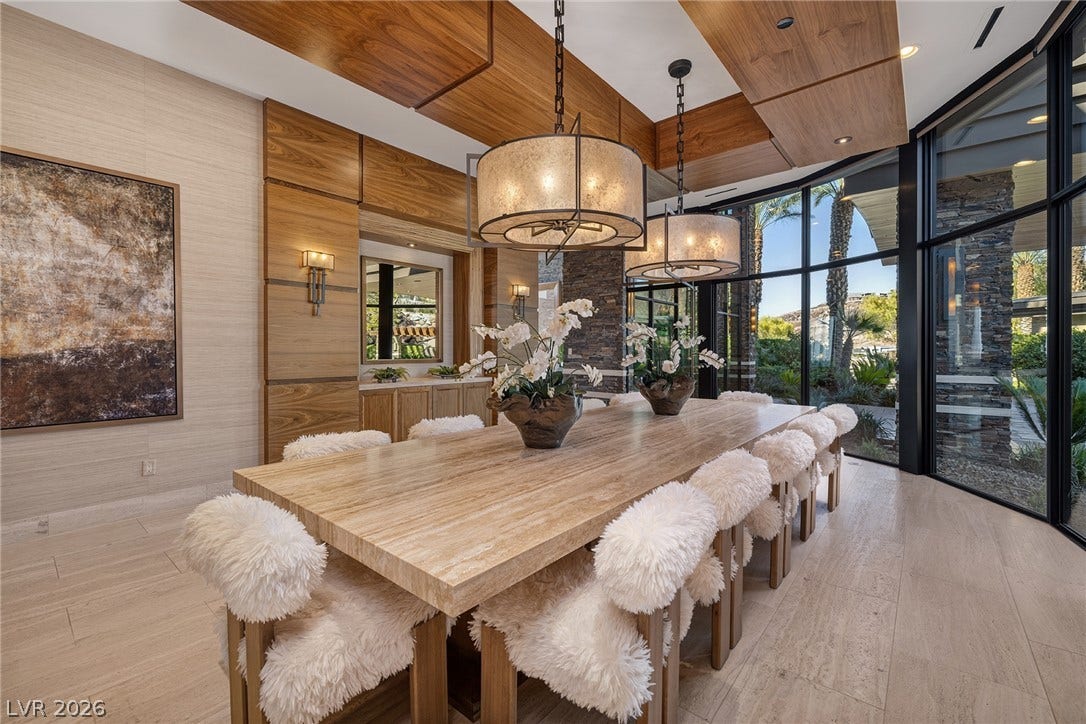 761 Dragon Ridge Drive, Henderson, NV 89012 Striking architectural paneling and towering walls of glass frame a sophisticated dining area.