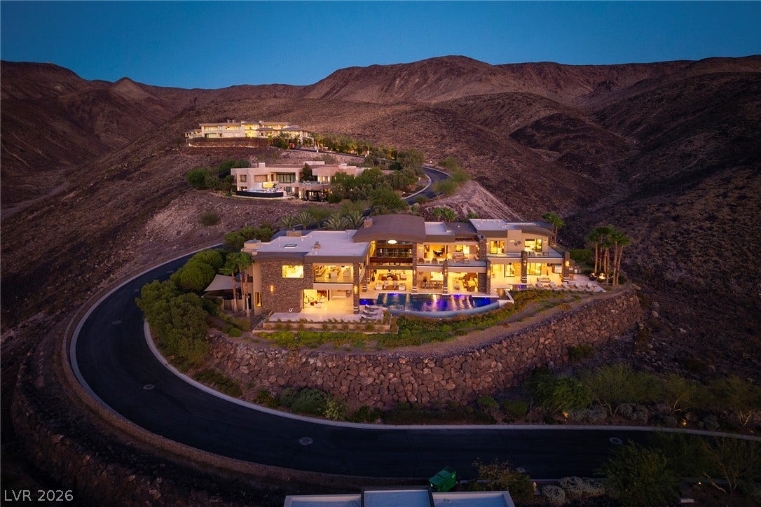 761 Dragon Ridge Drive, Henderson, NV 89012 Dramatic hillside architecture commands sweeping desert and mountain views from its elevated perch.