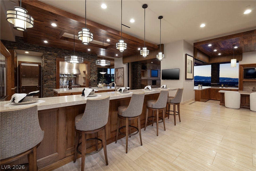 761 Dragon Ridge Drive, Henderson, NV 89012 Gleaming tile floors and rich wood-paneled ceilings elevate this expansive open bar and kitchen area.