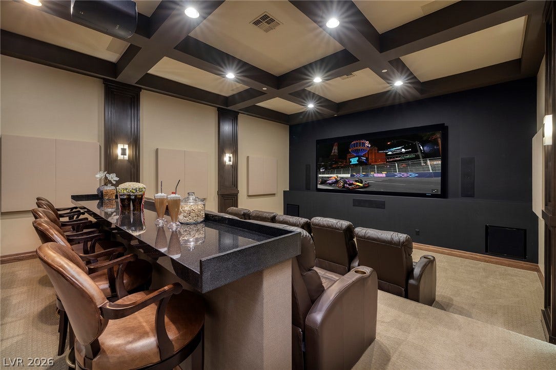 761 Dragon Ridge Drive, Henderson, NV 89012 A tiered home theater features a built-in bar counter under a coffered ceiling.