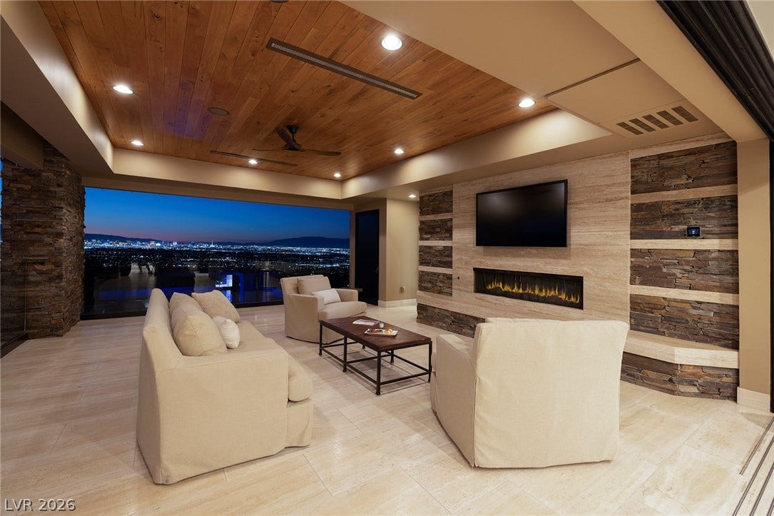 761 Dragon Ridge Drive, Henderson, NV 89012 Rich wood ceilings and polished tile flooring frame sweeping city light views.