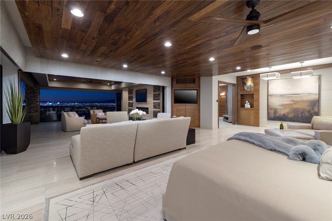 761 Dragon Ridge Drive, Henderson, NV 89012 Rich wood ceilings and stone floors define this spacious bedroom suite showcasing glittering city views.