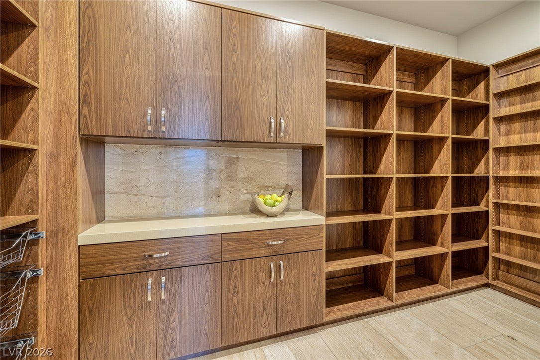 761 Dragon Ridge Drive, Henderson, NV 89012 Abundant built-in storage and sleek countertops define this functional walk-in pantry space.
