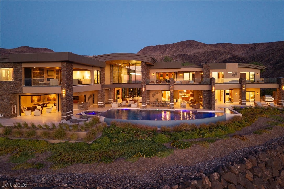 761 Dragon Ridge Drive, Henderson, NV 89012 Dramatic desert mountains frame this multi-level contemporary estate with its custom curved infinity pool.