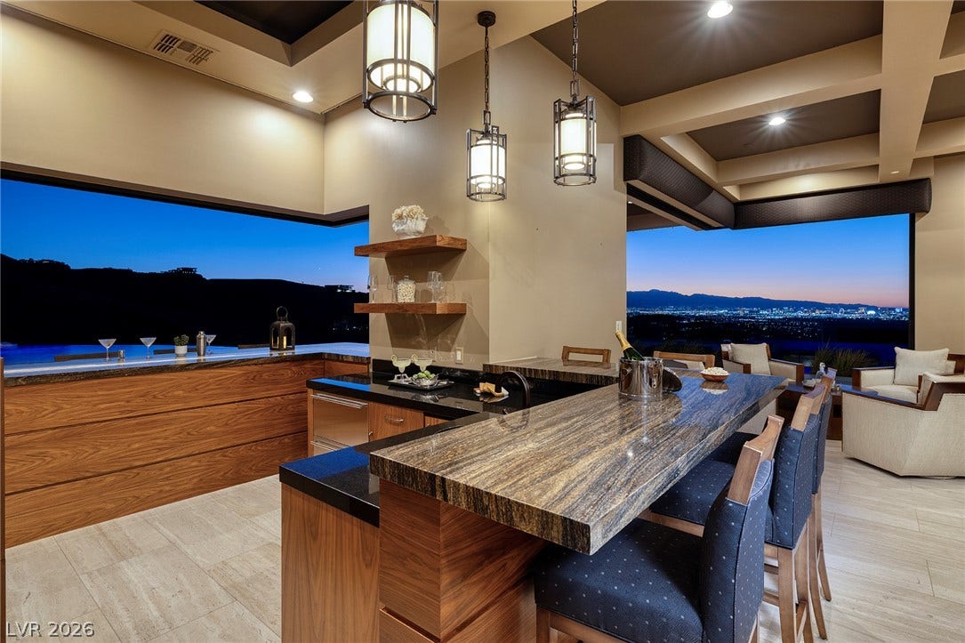 761 Dragon Ridge Drive, Henderson, NV 89012 Granite counters and custom wood cabinetry define this sleek bar space overlooking city views.