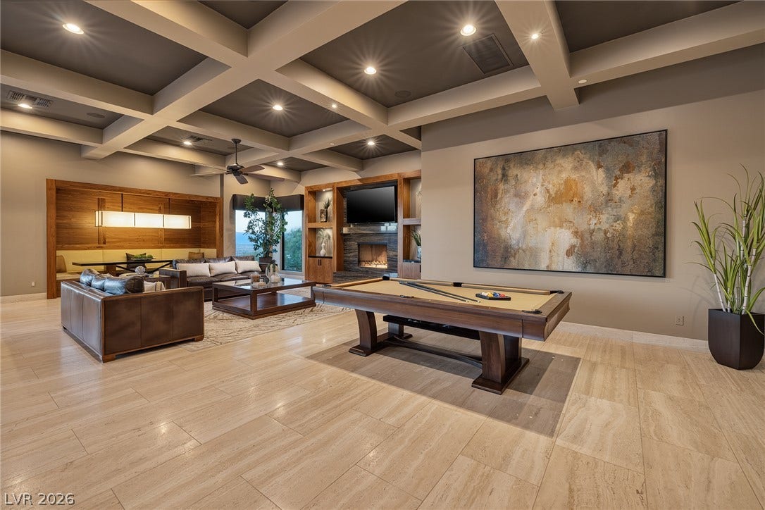 761 Dragon Ridge Drive, Henderson, NV 89012 Exquisite coffered ceilings and polished stone tile floors define this sprawling entertainment space.