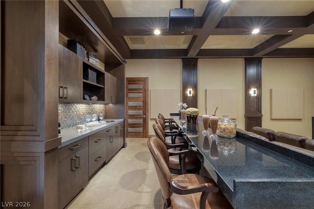 761 Dragon Ridge Drive, Henderson, NV 89012 A wet bar with custom cabinetry sits adjacent to the home theater space.