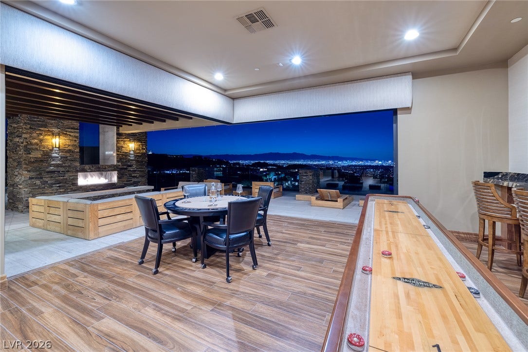 761 Dragon Ridge Drive, Henderson, NV 89012 Retracting glass walls merge the indoor recreation room with an expansive view terrace.