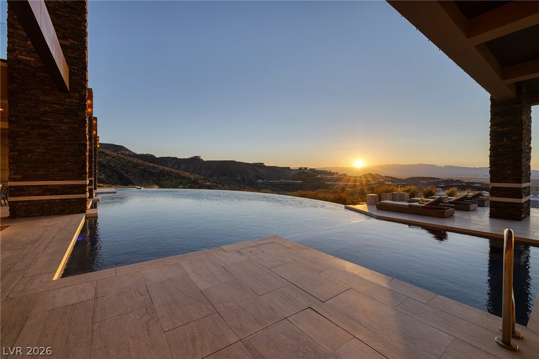 761 Dragon Ridge Drive, Henderson, NV 89012 An infinity pool looks out over sweeping mountain vistas and the setting sun.