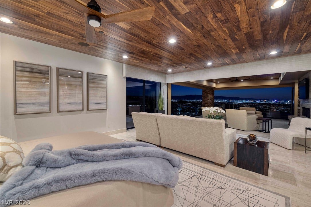 761 Dragon Ridge Drive, Henderson, NV 89012 Rich wood plank ceilings and pocketing doors frame sweeping city night views from this space.