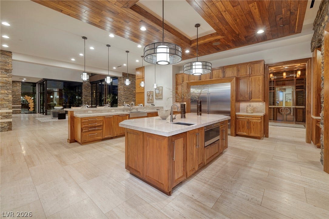 761 Dragon Ridge Drive, Henderson, NV 89012 Rich wood plank ceilings and stone accents frame this high-end culinary space with dual islands.