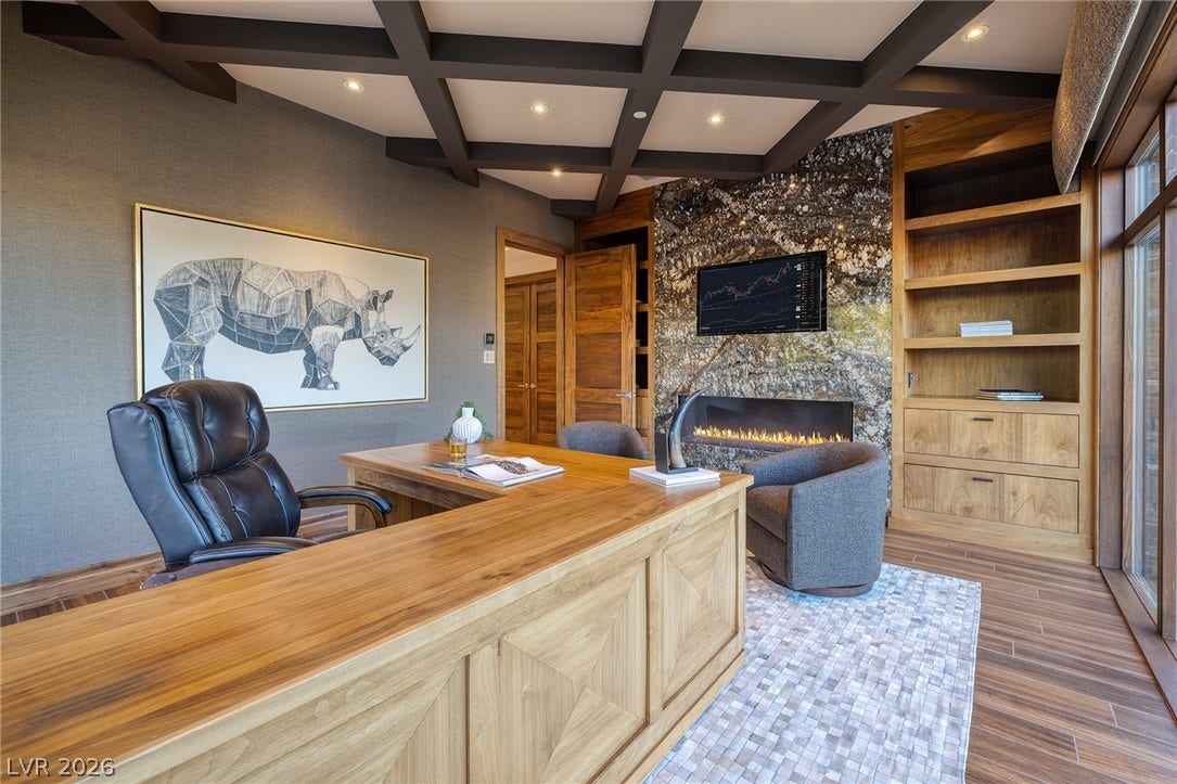 761 Dragon Ridge Drive, Henderson, NV 89012 Rich wood paneling and a coffered ceiling define this sophisticated executive study.