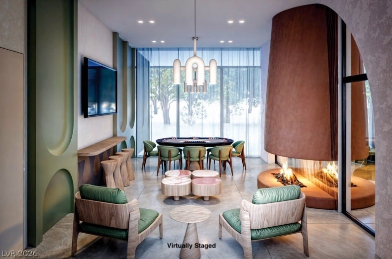 "Virtually Staged" Custom architectural details and a modern floating fireplace anchor this striking game room.