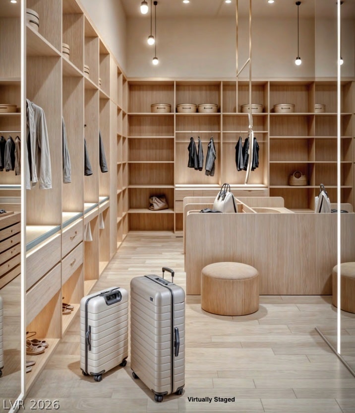 "Virtually Staged" Custom oak cabinetry and integrated lighting define this expansive wardrobe space.