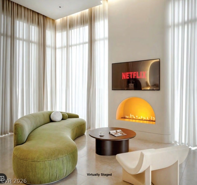 "Virtually Staged" Floor-to-ceiling windows and a modern arched fireplace define this elegant living space.