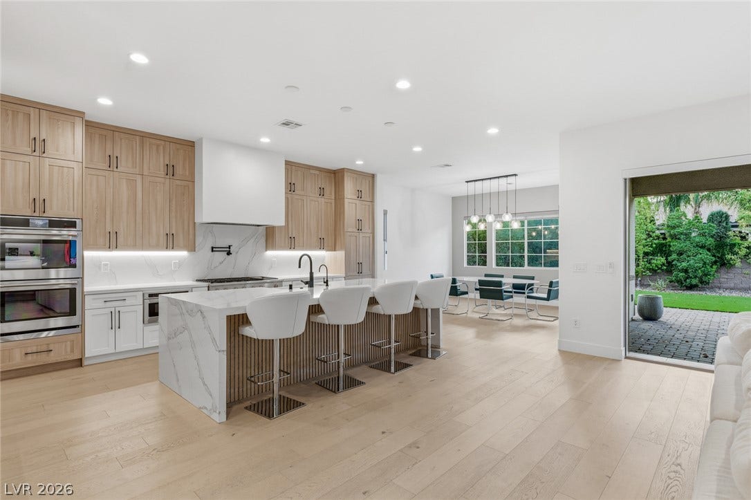 4078 San Franchesca Court, Las Vegas, NV 89141 A well-lit kitchen with sleek modern cabinetry and an inviting open-concept dining area.