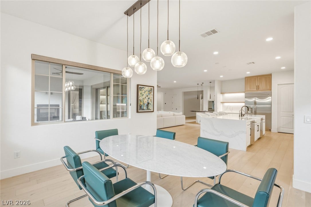 4078 San Franchesca Court, Las Vegas, NV 89141 An inviting dining space with light wood floors connects to an open-concept kitchen.